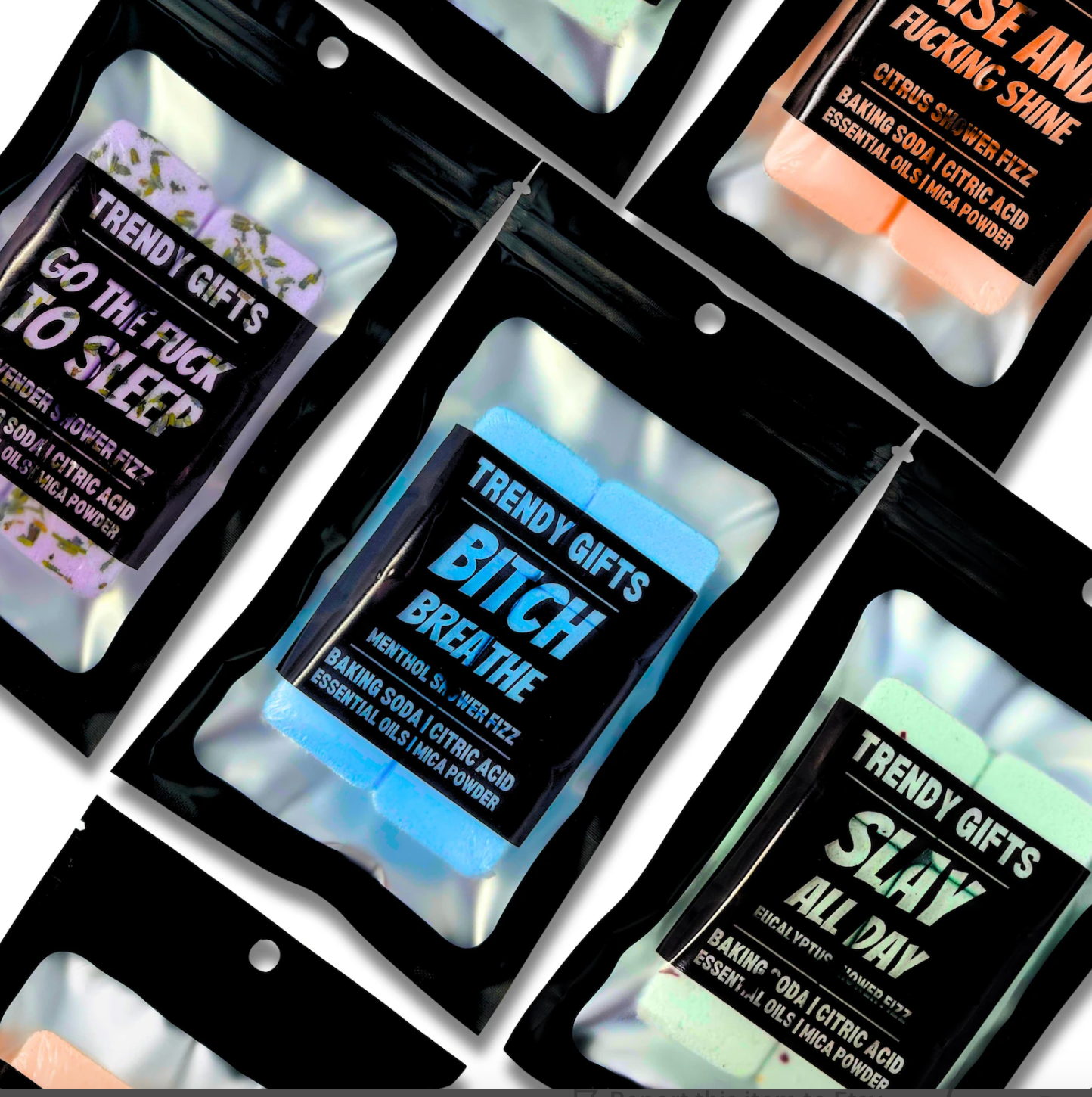 Assorted shower steamers in individual black packaging with different phrases on them, including 'TRENDY GIFTS', 'GO TO SLEEP', 'Bitch Breathe', and 'SLAY ALL DAY'.