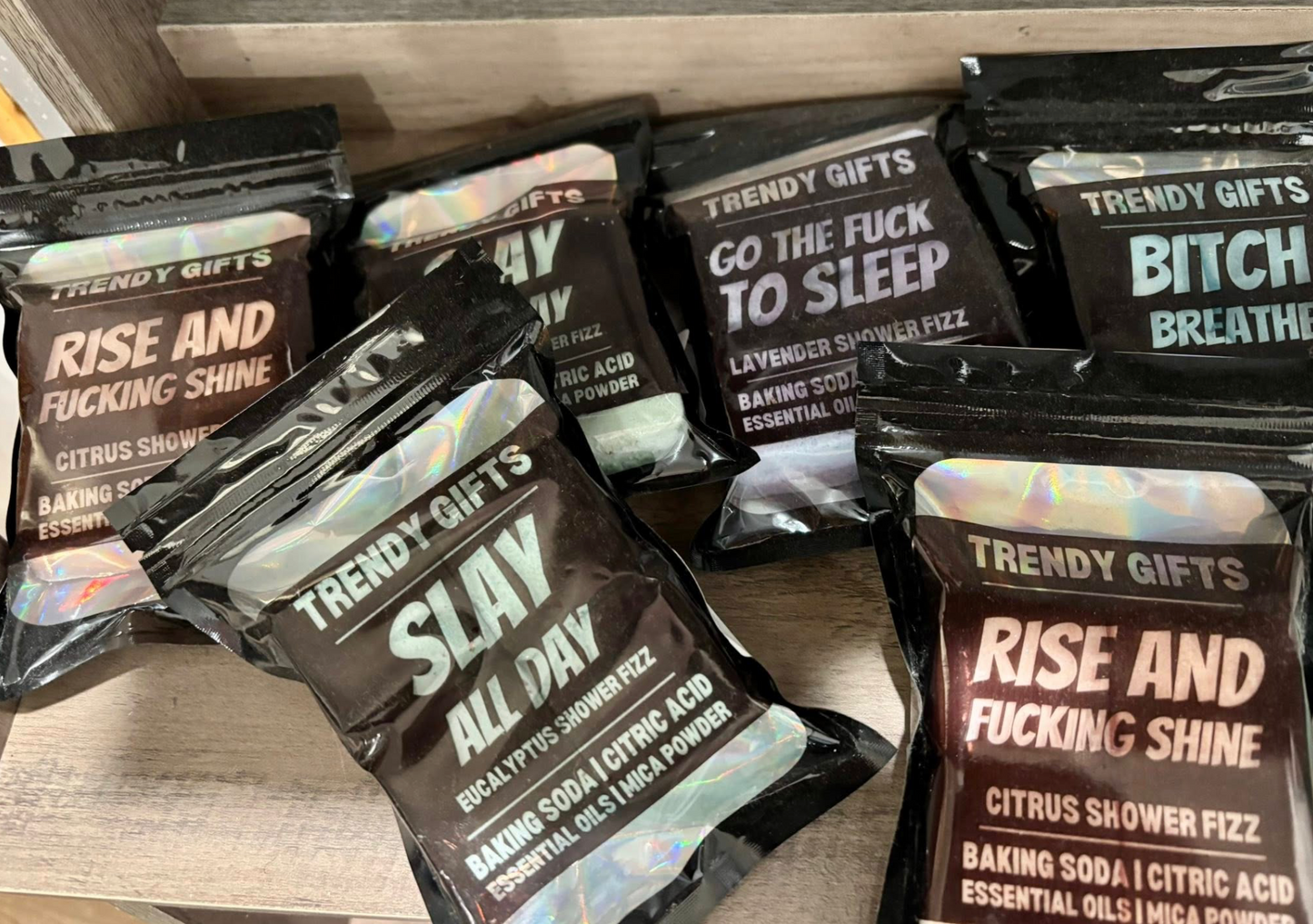 Packaged products with bold text on a wooden surface