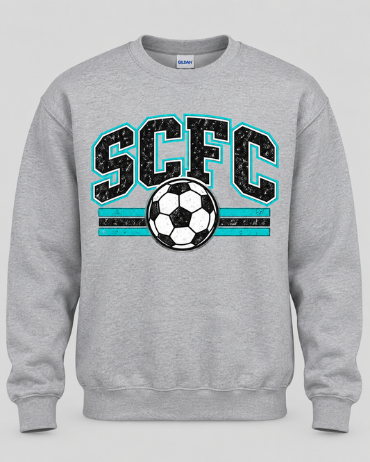 A heather gray crewneck sweatshirt featuring a distressed graphic on the front with the text 'SCFC' in black outlined with turquoise, and a black and white soccer ball centered below.